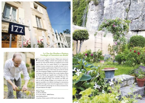 Clos des Moulins Poitiers B&B courtyard garden with stone walls, flowers, and historic building entrance at 177 rue
