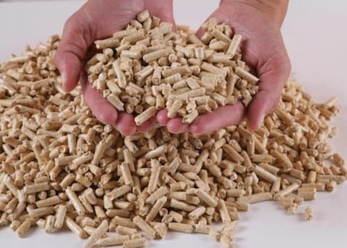 Hand holding wooden pellets at Clos des Moulins bed and breakfast in Poitiers, France