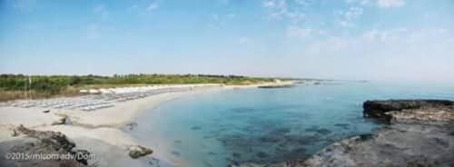 Pristine sandy beach with turquoise waters at Masseria Vittoria in Acaya, Vernole, Lecce, Italy