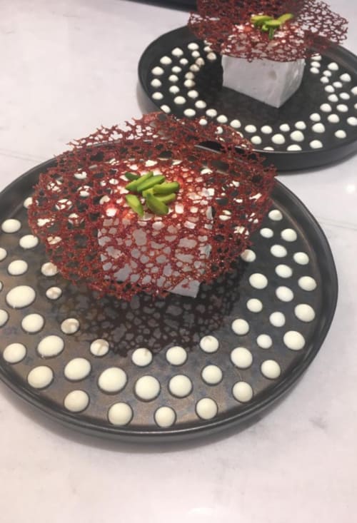 Red velvet cake with white pearl decorations and green leaf garnish at Three Little Pigs hotel, Blandford Forum