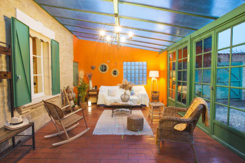 intérieur de la véranda confortable du mas des olivades avec siège et fauteuil