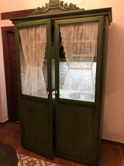 Green French doors with lace curtains opening to city views in Almagro room at Complejo Turístico Retiro del Teatro