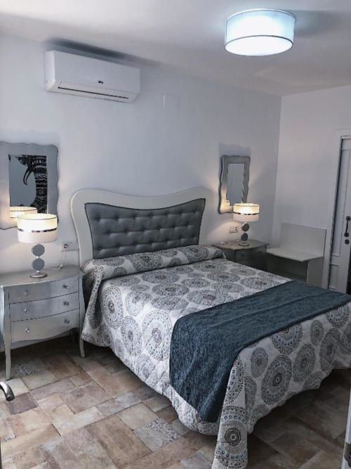 Modern bedroom in Deluxe Apartment AB at Complejo Turístico Retiro del Teatro, Almagro. Queen bed with patterned bedding,