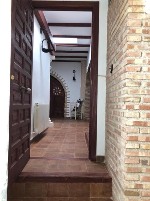 Hallway entrance to Room 3 at Complejo Turístico Retiro del Teatro, featuring terracotta tile flooring, dark wood door frame,