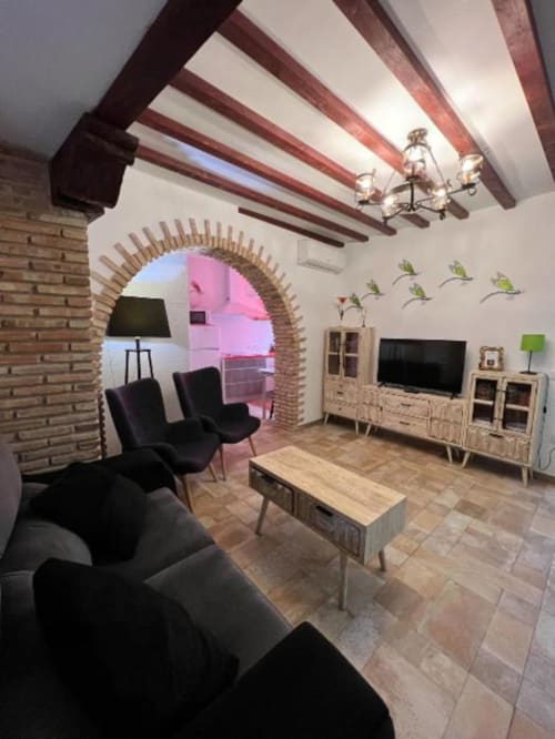 Modern living room in Deluxe Apartment at Complejo Turístico Retiro del Teatro, Almagro, with exposed beams, brick arch,