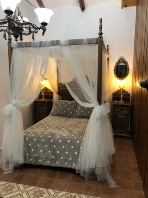 Elegant four-poster canopy bed with white sheer curtains and polka dot bedding in Room 5 at Complejo Turístico Retiro del