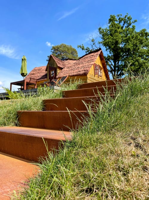 Les Refuges Du Chalet in Jalhay: charming yellow chalet with terracotta roof and rustic metal steps leading uphill.