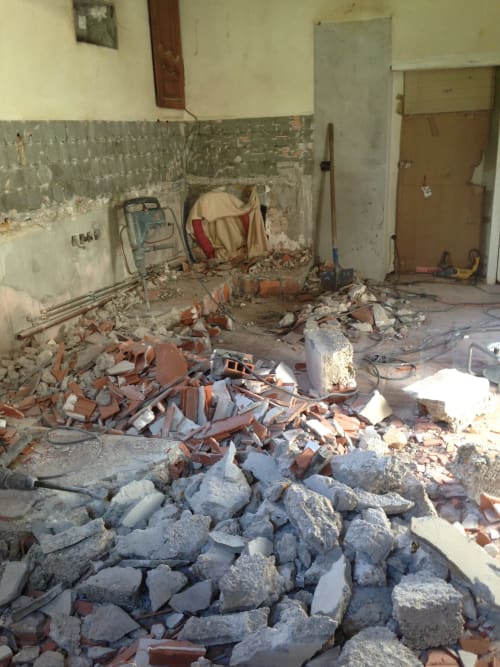 Interior renovation in progress at Domaine de l'Ocrerie in Pourrain showing demolition debris and construction materials
