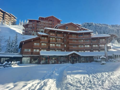 Refuge alpin CMD Méribel Le Pralin aux Les Allues enneigées avec vue sur les montagnes et arbres givrés