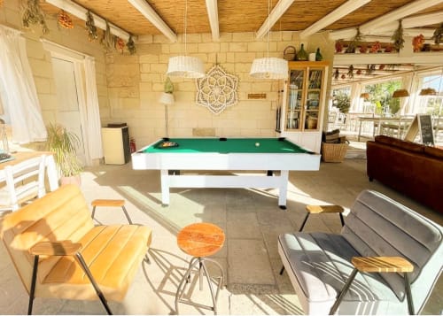 Bright game room at Masseria Vittoria B&B in Acaya with pool table, seating areas, and natural light