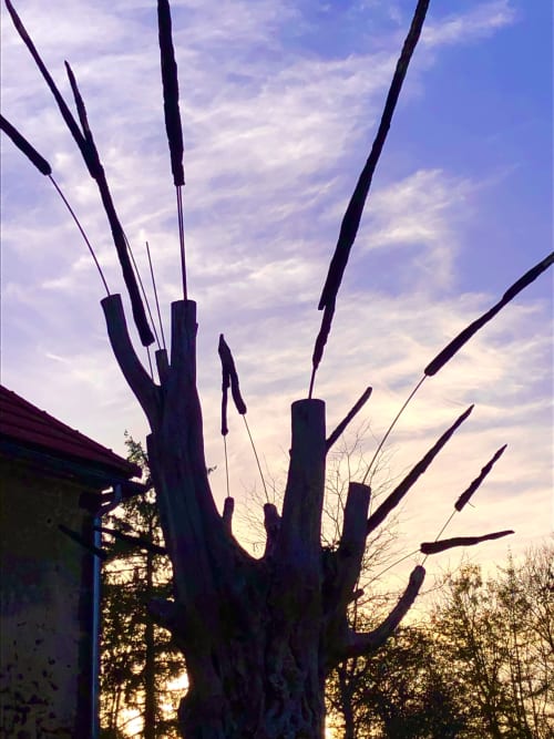 Artistic cattail sculpture silhouetted against twilight sky at Domaine de l'Ocrerie, Pourrain