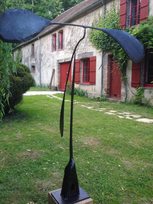 Modern black sculpture in garden of Domaine de l'Ocrerie, a French bed and breakfast in Pourrain with historic stone building