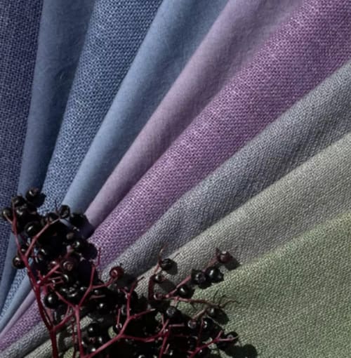 Fabric color swatches in blue, purple, and beige tones displayed at Domaine de l'Ocrerie, Pourrain