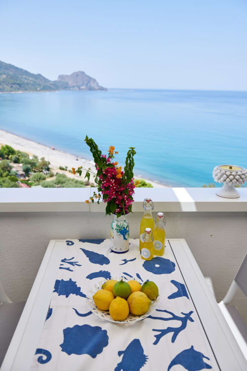 Coastal terrace at CefalHome with vibrant bougainvillea, lemons, and Mediterranean sea views