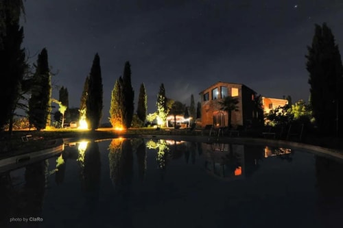 Agriturismo Quarantallina in Tuscany with illuminated pool at night 