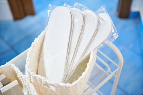 Pack of disposable sanitary pads in cream basket at CefalHome hotel, Roma