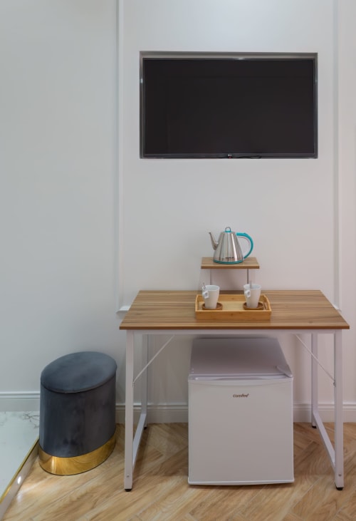 Modern Standard Room at Garibaldi 125 Naples with desk, flat screen TV, minibar, and comfortable seating