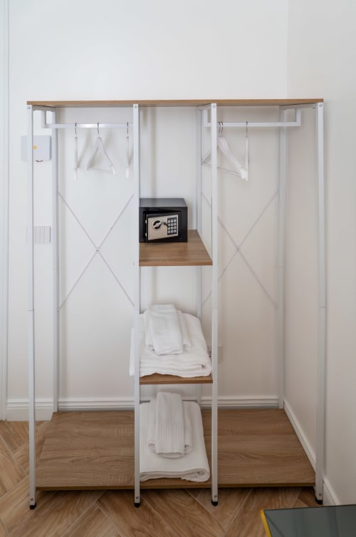 Modern white wardrobe at Garibaldi 125 Naples B&B with hanging space, shelves, towels, and built-in safe