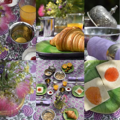 Elegante desayuno en Domaine de l'Ocrerie con croissants, zumo de naranja, mermeladas, flores y porcelana fina