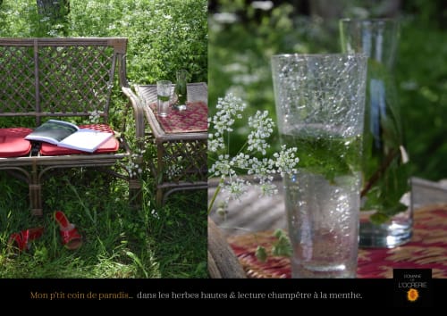 Garden seating at Domaine de l'Ocrerie with baby's breath flowers, water glasses, and reading nooks among lush greenery in