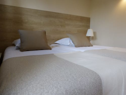Modern bedroom at Villa Thébaïde with wooden headboard, white bedding, and elegant décor in Laudun L'Ardoise