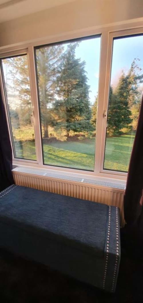 Contemporary suite window with garden views, Dublin Exchange Suites villa with trees and green lawn visible through modern