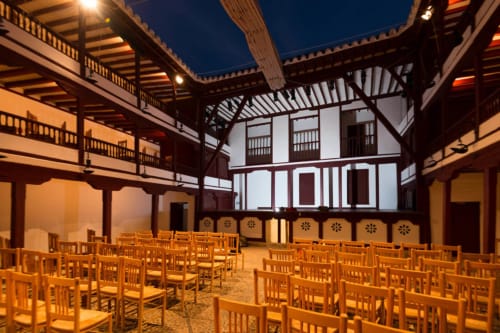Teatro Retiro courtyard at night with wooden chairs and traditional Spanish architecture in Almagro, Ciudad Real