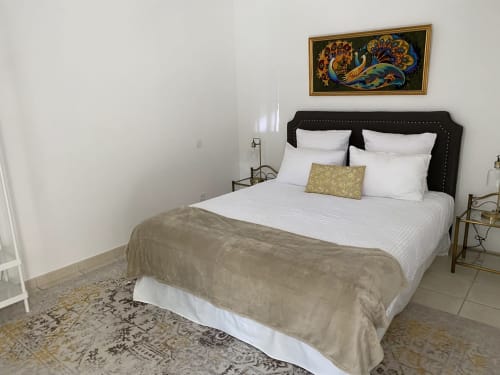 Chambre de l'Appartement Foix au Domaine de Bize avec lit queen-size aux draps blancs, tête de lit noire et motifs dorés