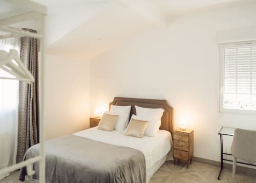 Bright bedroom in Appartement Carcassonne at Domaine de Bize, Mirepoix with queen bed, wooden nightstands, and garden views