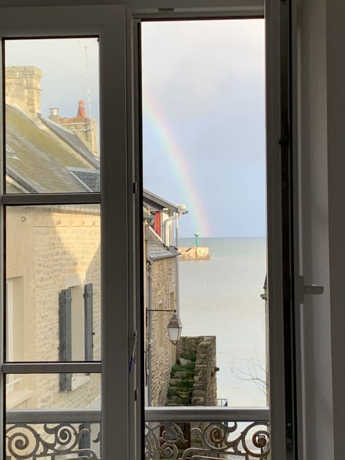 Rainbow over sea view from Les Filles du Bord de Mer cottage in Port-en-Bessin, France