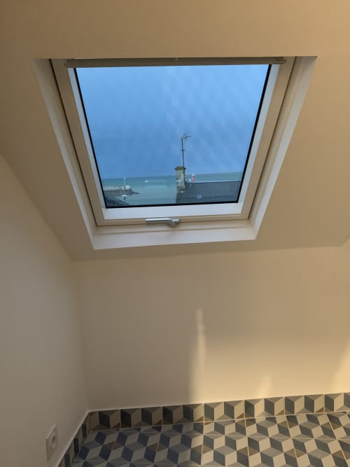 Skylight window overlooking Port-en-Bessin harbor and sea view from Simone sur Mer cottage at Les Filles du Bord de Mer hotel