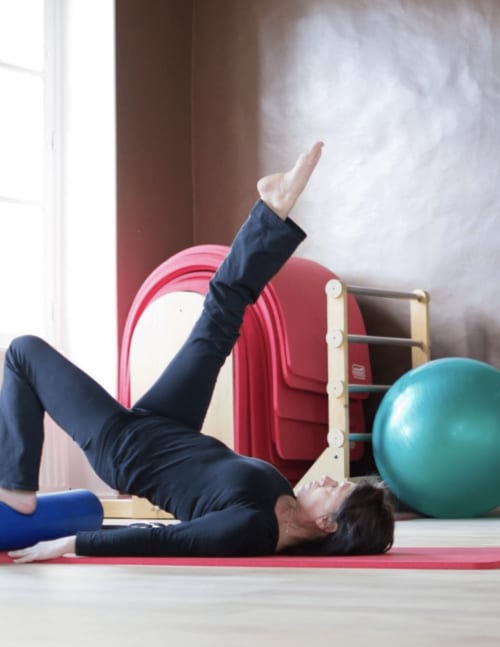 Woman doing pilates exercise at Domaine de Bize wellness center in Mirepoix, Ariège