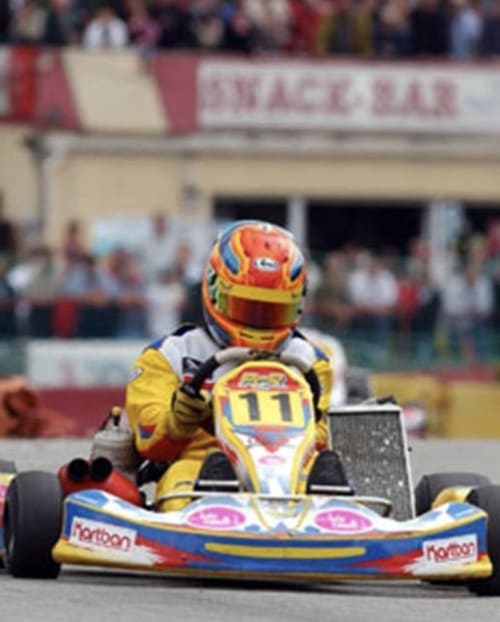 Yellow and red go-kart racer at outdoor track near Mirepoix, Ariège