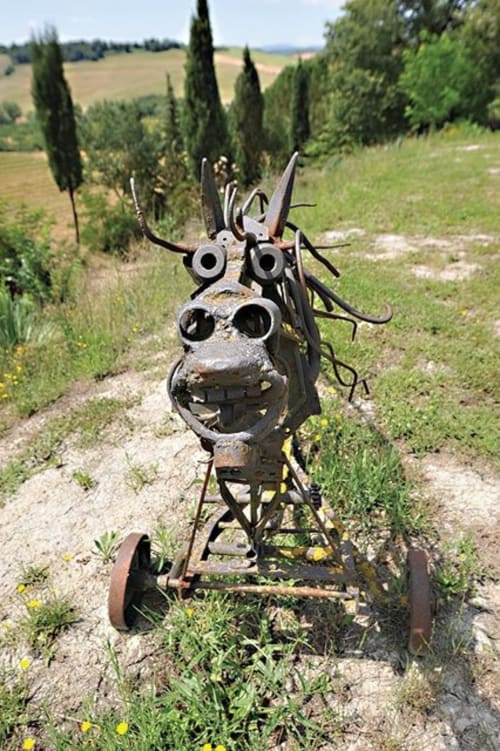 Artistic recycled iron sculpture created by the owner and integrated into the natural garden landscape
