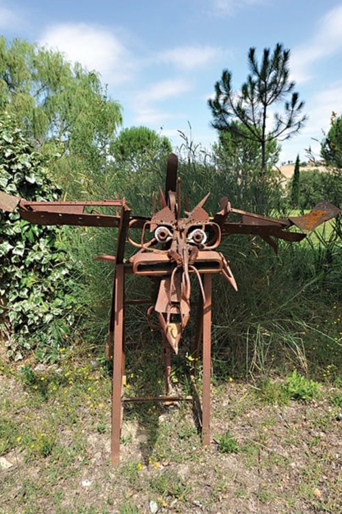 Artistic sculpture made from recycled metal by the owner, decorating the garden of a Tuscan agriturismo