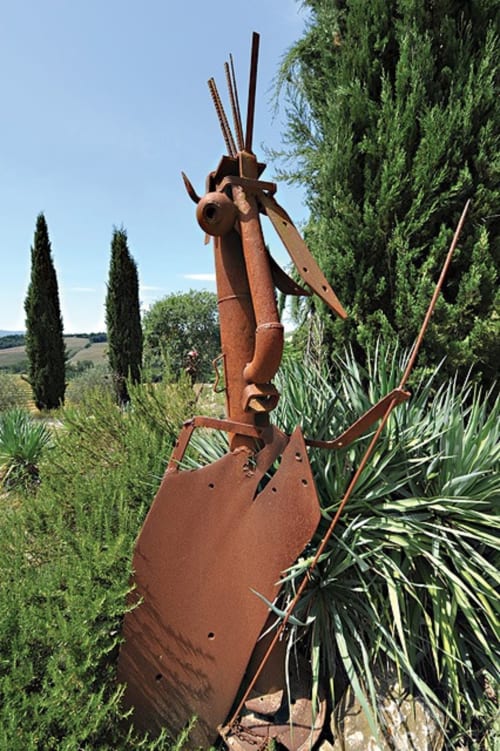 Recycled metal sculpture created by the owner, displayed in the garden of Agriturismo Quarantallina in Tuscany