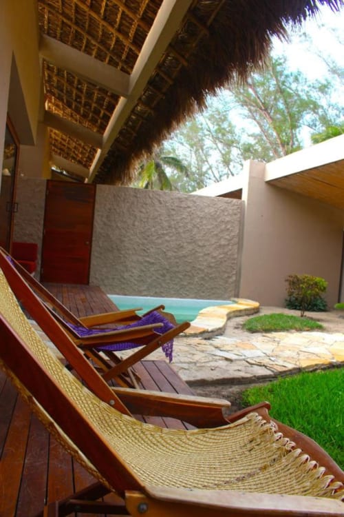 Hammocks on wooden deck overlooking pool and courtyard at Isla Tajín Beach & River Resort in Tuxpan