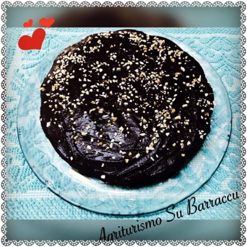 Rich chocolate cake with gold dust topping at Agriturismo Su Barraccu hotel in Loceri, Italy