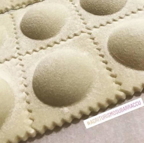 Close-up of ravioli pasta with decorative crimped edges at Agriturismo Su Barraccu in Loceri