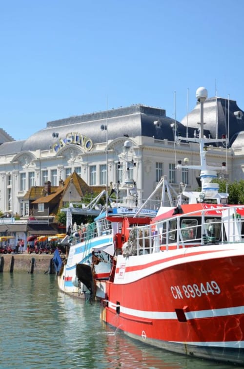 Casino building and red boats at Trouville-sur-Mer harbor, Hotel Le Trouville location