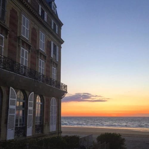 Hotel Le Trouville beachfront building at sunset overlooking Trouville sur Mer beach