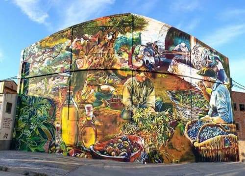 Colorido mural en el Cuartel del Montsant que muestra escenas de cosecha agrícola y vida rural en La Granadella
