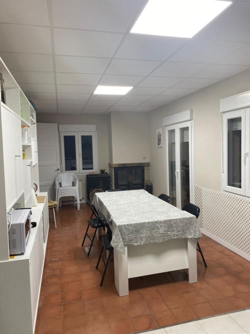 Sala de estar y comedor compartida en el apartamento Cuartel del Montsant de La Granadella con pisos de terracota y vistas a las montañas