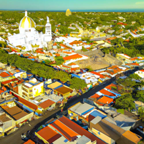 Aerial view of Isla Tajín Beach & River Resort in Tuxpan, Mexico with colorful buildings and white dome church