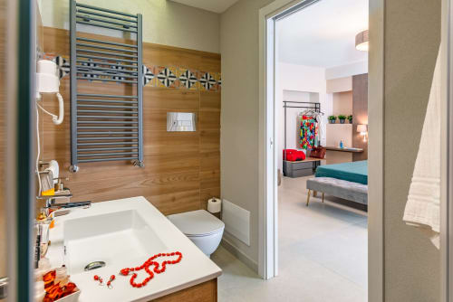 Bagno moderno nella Suite Nero D'Avola di Macramè Fazello, Sciacca con pareti in legno, scaldasalviette e vista su