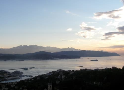 Tramonto sul porto di Vernazza con montagne e barche, località balneare SoleMagia in Italia