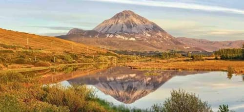 Volcanic mountain reflected in still water with farmland near Duffy Lodge, Co Donegal
