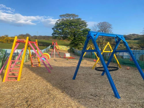 Colorful playground with swings and climbing frames at Duffy Lodge, Co Donegal