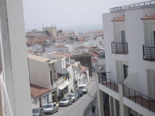 Aerial view of Casa do Sol Algarve hotel in Lagos with white buildings, terracotta roofs, and street below
