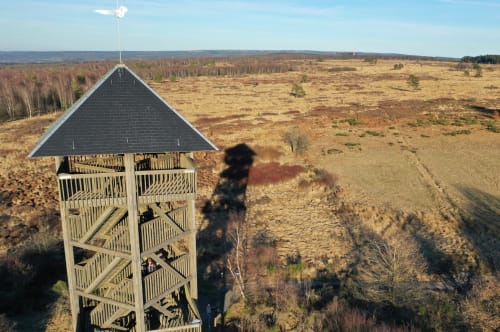 Wooden observation tower with black roof at Les Refuges Du Chalet in Jalhay, Belgium, overlooking moorlands